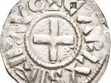 a close up of a coin with a cross on it