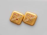 a pair of gold and ruby earrings