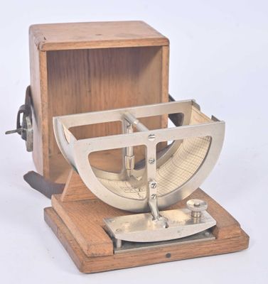 a wooden box with a metal object inside of it