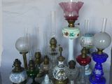 many different types of glass vases and lamps on the table