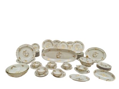 a lot of white and gold plates and bowls