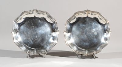 pair of silver plated dishes on stands on a white surface
