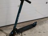 a scooter parked in front of a garage door