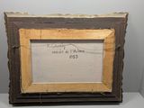 an old picture frame sitting on top of a white table