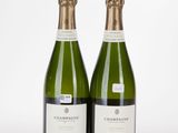 two bottles of champagne sitting next to each other on a table