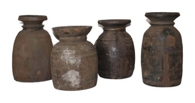 four old vases are lined up in a row on a white background