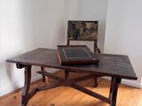 a wooden table with a black tile on top of it