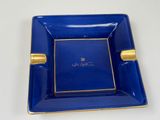 an image of a blue and gold plate with a picture on it