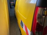 a yellow truck parked in a garage next to a yellow wall