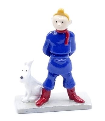 figurine of a man and a dog on a white surface