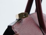 a close up of a handbag with a ring on top of it