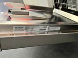 a picture of a dishwasher that has a sharp label on it