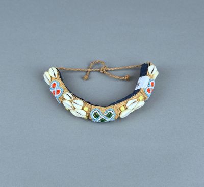 un gros plan d'un collier posé sur une surface grise