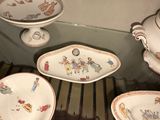 three plates and a bowl on display in a glass case
