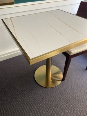 a white table and two chairs in a room