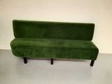 a green couch that is sitting on a white floor