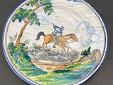 a plate with a painting of a horse and rider on it