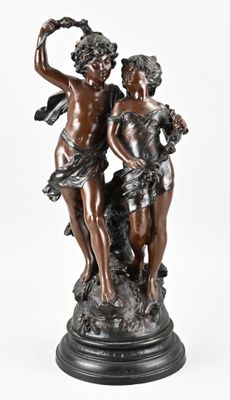 an antique bronze statue of two cherensils on a marble base
