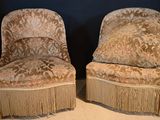 two chairs with fringes on them sitting on the floor