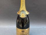 a bottle of champagne with a gold label on it