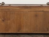 a wooden chest with a metal handle on top of it