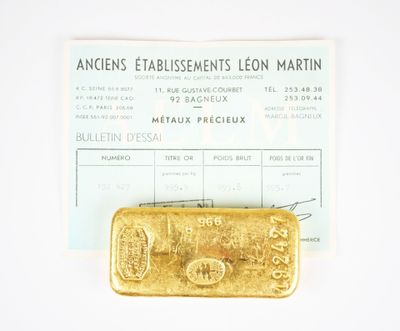 a gold bar sitting on top of a piece of paper