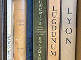 many books in a cardboard box on the shelf