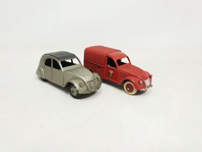 two toy cars sitting next to each other on a white surface