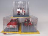 three toy cars in a display case on a table
