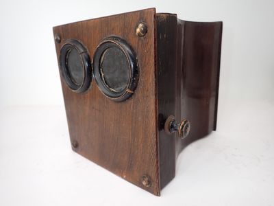 a small wooden box with two speakers on it