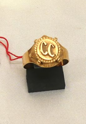 a gold ring with a red string around it