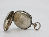 an old pocket watch with a chain hanging from it ' s side