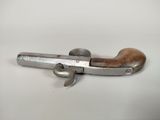 a close up of an old gun on a white surface