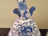 pair of blue and white vases sitting on top of a wooden table