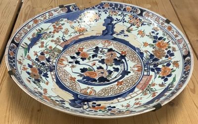 a large blue and white plate on a wooden table