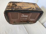 an old radio sitting on top of a white couch