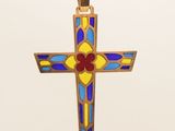 a close up of a cross on a chain with a white background