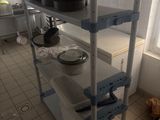 a shelf with pots and pans on it in a kitchen