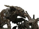 a bronze statue of a boar and a bird on a rock