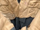 a close up of a pair of jeans and a jacket