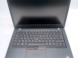 the laptop is open on a white surface with a black keyboard