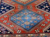 an oriental rug with a blue and red design on it