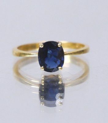 an image of a ring with a blue sapphire stone