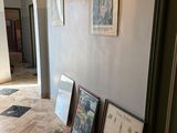 three framed pictures on the floor of a hallway