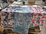 a table with a bunch of cloths on top of it