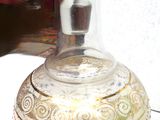 a glass bottle with a lid sitting on a table