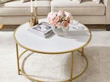 a coffee table with flowers on it in a living room