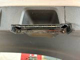 a close up of a car door handle with a hole in it