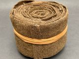 a close up of a roll of fabric on a gray surface