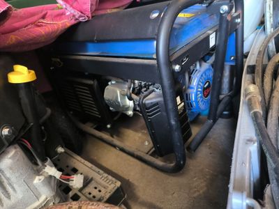 a small generator that is sitting in the back of a truck